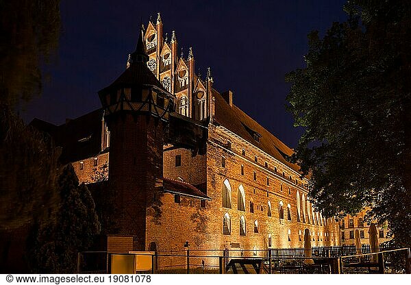 Malbork Castle in Poland  Middle Castle illuminated at night  medieval fortress of Teutonic Knights Order dating back to 13th century  UNESCO World Heritage Site