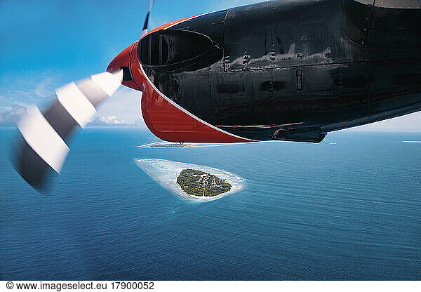 Maldives  Kolhumadulu Atoll  Personal perspective of paraglider flying over small islet in Indian Ocean