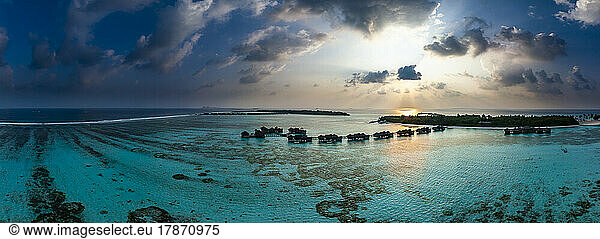 Maldives  North Male Atoll  Lankanfushi  Aerial view of Indian Ocean at sunset with tourist resort bungalows in background