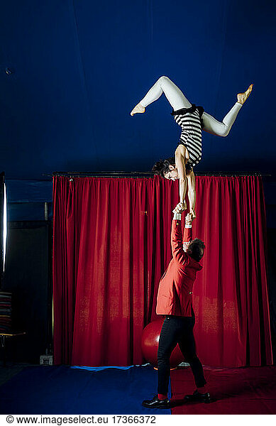Male and female acrobats performing together in circus