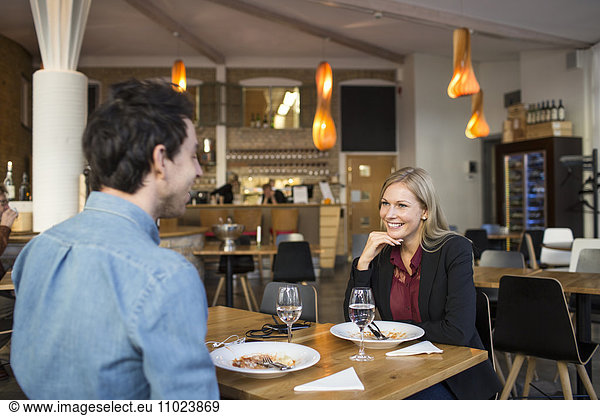 Male and female business colleagues having discussion during business meeting