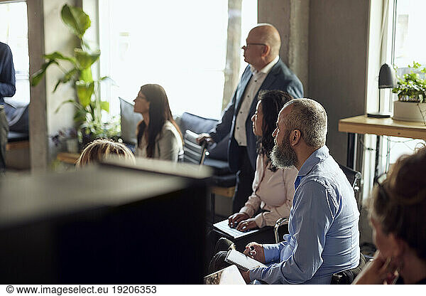 Male and female colleagues at creative office during meeting