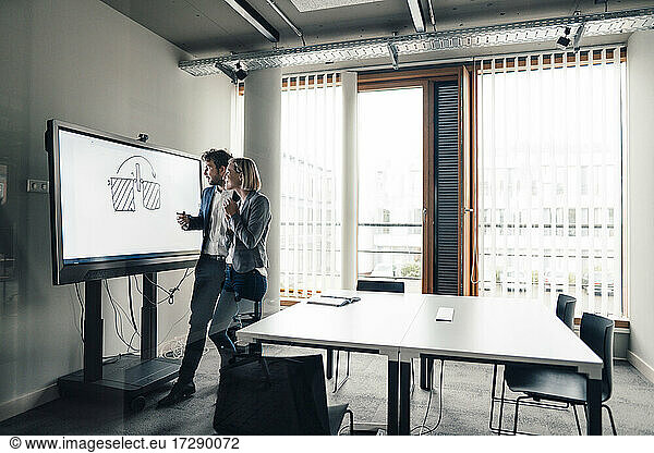 Male and female colleagues planning business strategy in office