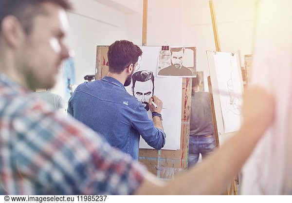 Male artists sketching in art class studio