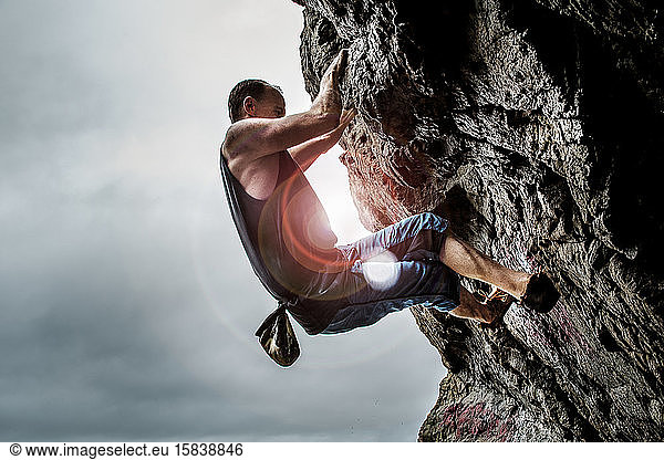 male athlete bouldering on rocks in san francisco