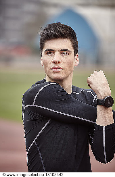Male athlete exercising on sports track