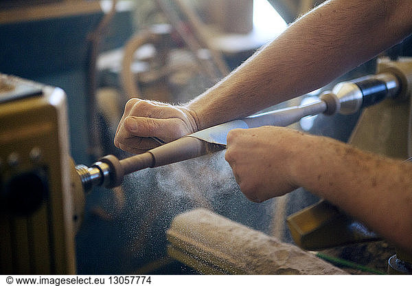 Male carpenter using machinery in workshop