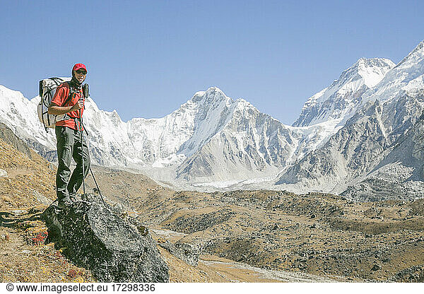 Male climber poses while trekking high above Everest Basecamp