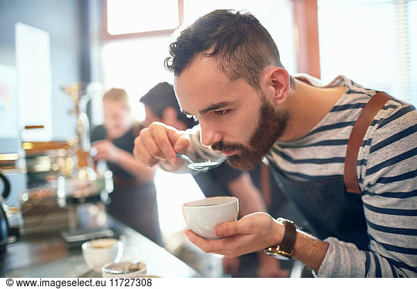 Male coffee roaster tasting coffee