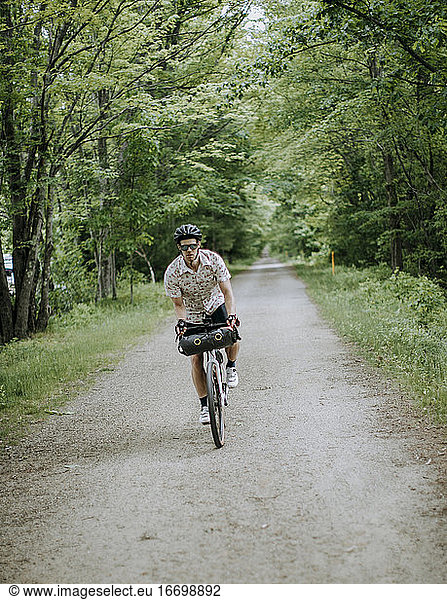 male cyclist rides bike along East Coast Greenway  Saco  Maine