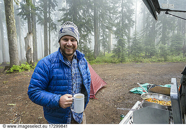 Male Drinking Coffee Making Breakfast While Camping