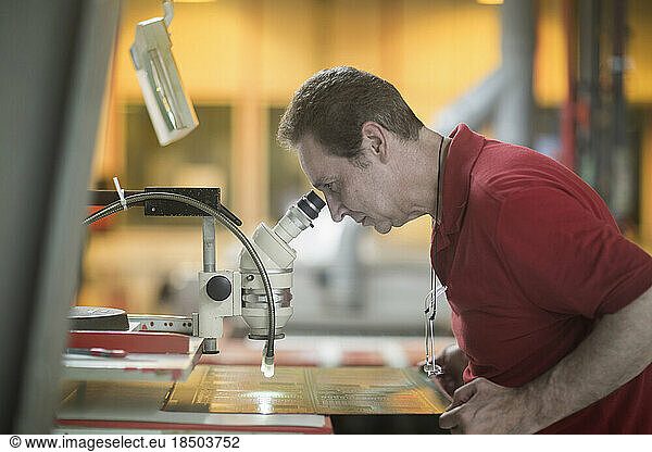 Male engineer examining circuit board in industry  Hanover  Lower Saxony  Germany