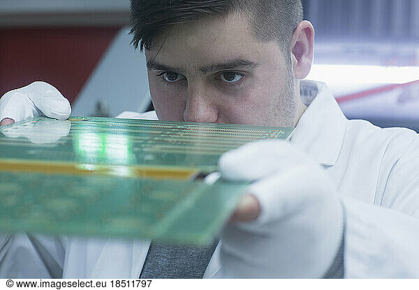 Male engineer examining circuit board in industry  Hanover  Lower Saxony  Germany