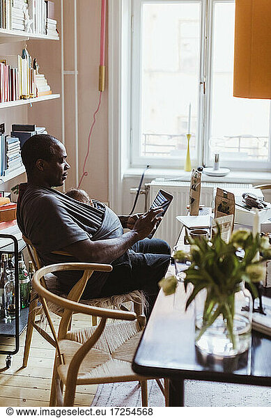 Male entrepreneur using digital tablet at home office