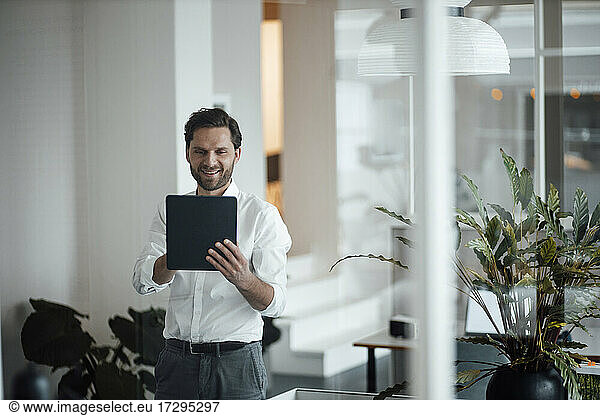 Male entrepreneur using digital tablet at office
