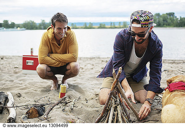 Male friends preparing for campfire