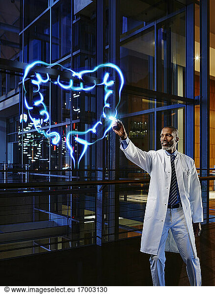 Male gastroenterologist examining large intestine with light painting at hospital