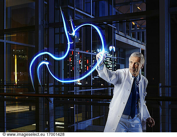 Male gastroenterologist light painting esophagus in laboratory at hospital