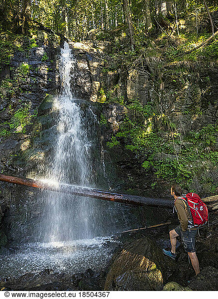 Male hiker admiring waterfall in the Black Forest  Baden-Württemerg  Germany