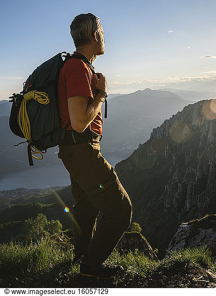 Male hiker looking at view while standing on mountain during sunset  Orobie  Lecco  Italy