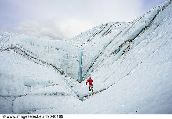 Male hiker on Root Glacier Wrangell St. Elias National Park and Preserve near McCarthy  Alaska