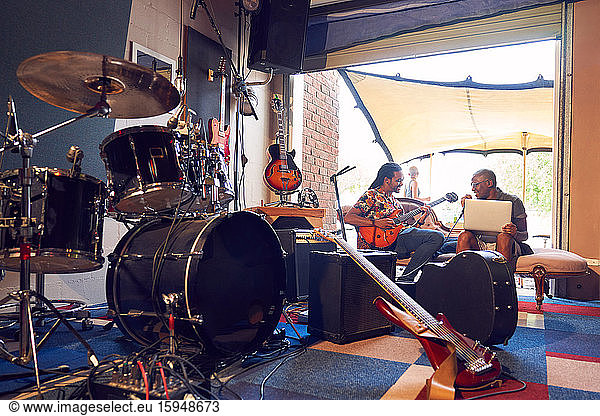 Male musicians practicing in garage recording studio