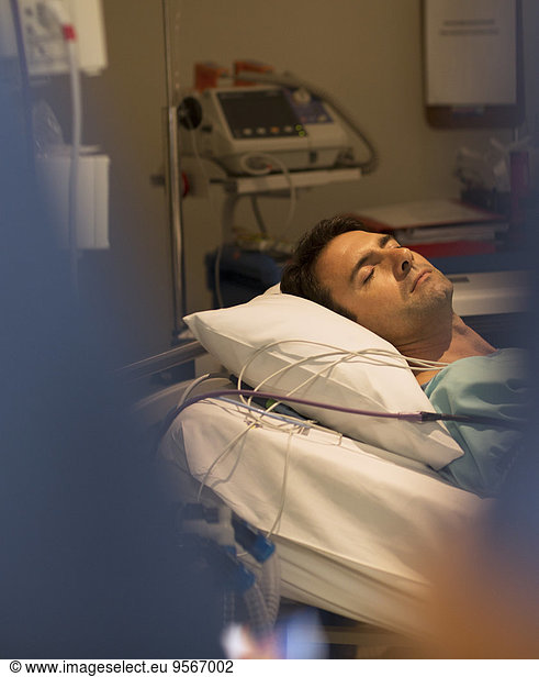 Male patient sleeping in hospital bed