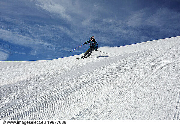 male skier racing on a ski piste