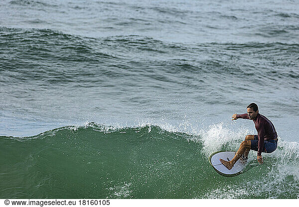 Male surfing wave in Australia