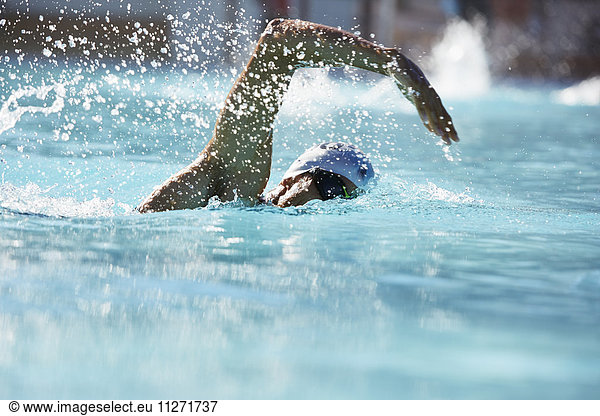 Male swimmer athlete swimming in swimming pool
