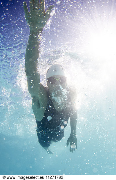 Male swimmer athlete swimming in swimming pool