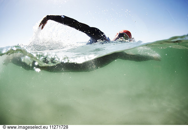 Male swimmer triathlete swimming in ocean