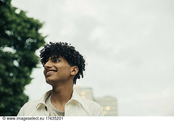 Male teenager with curly black hair