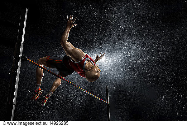 Male track and field athlete high jumping