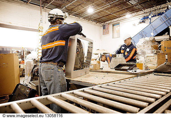 Male workers working in recycling plant