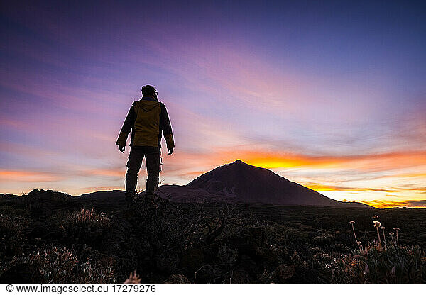 Man admiring view while standing on mountain at El Teide National Park  Tenerife  Spain