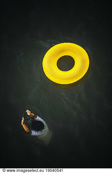 Man and colorful inner tube.