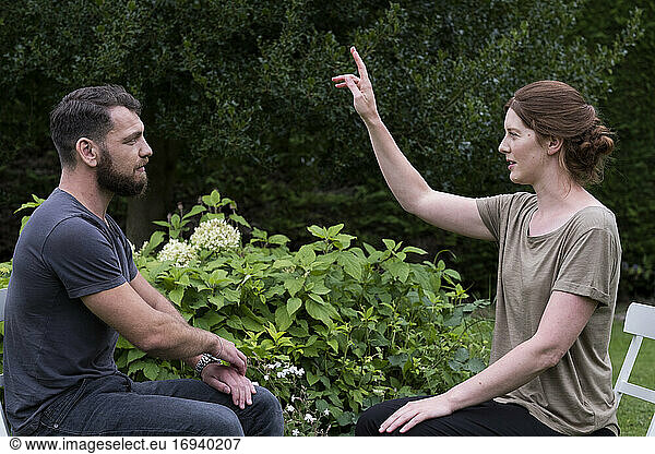 Man and female therapist in a garden  sharing techniques of EFT