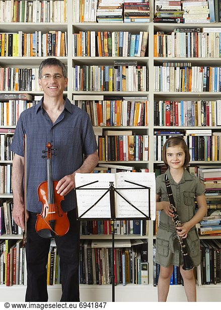 Man and Girl Holding Instruments