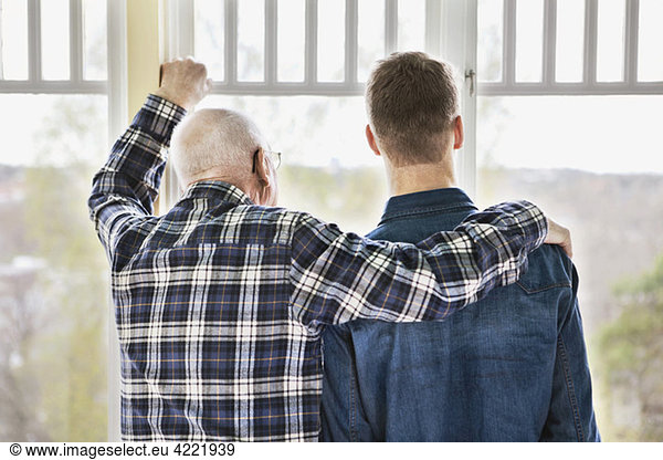 Man and guy by window cheering