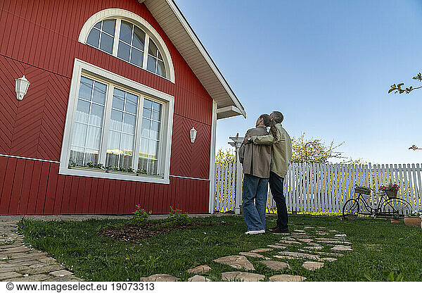 Man and woman admiring house