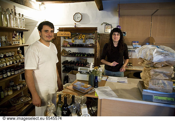 Man and woman in shop with italian food