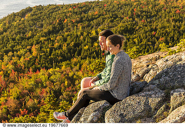 Man and woman looking at view while hiking along Beehive Trail  Acadia National Park  Maine  USA