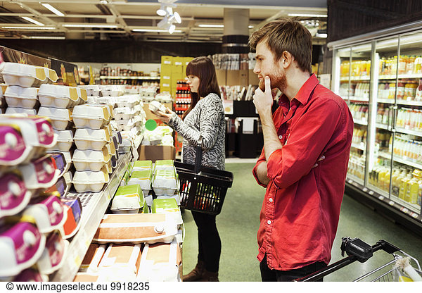 Man and woman shopping at supermarket
