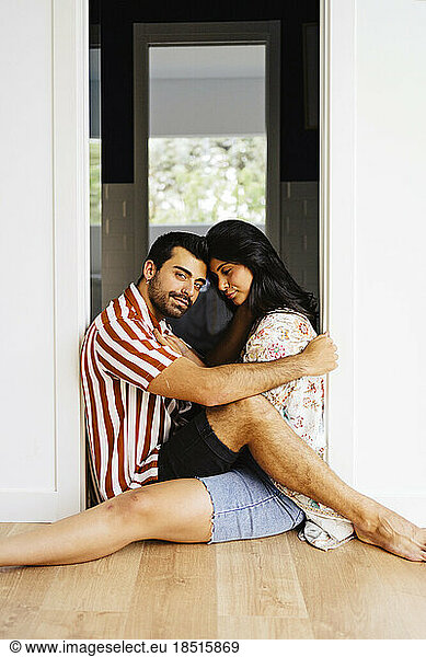 Man and woman sitting at doorway of tiny house
