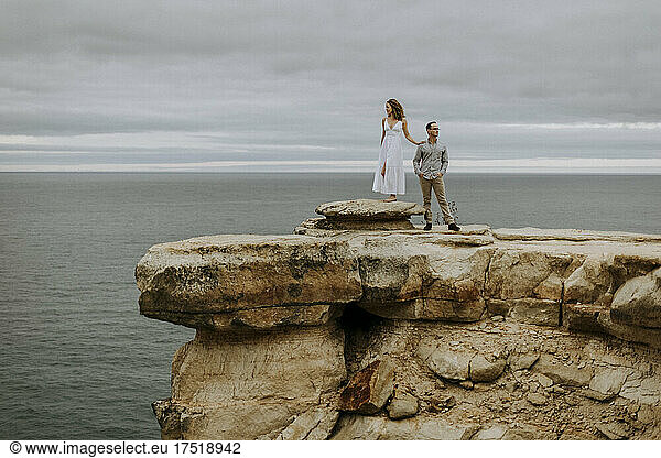 man and woman stand on edge of cliff  Pictured Rocks  Michigan