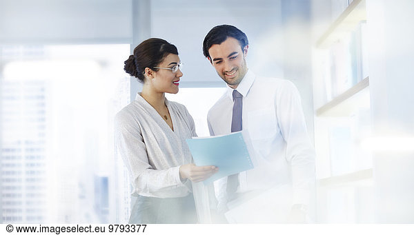 Man and woman talking in office