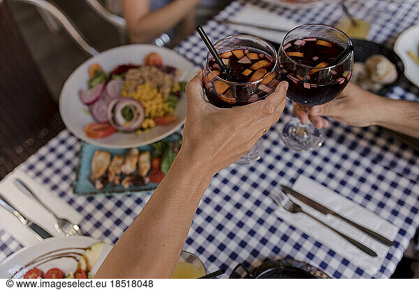 Man and woman toasting sangria in restaurant