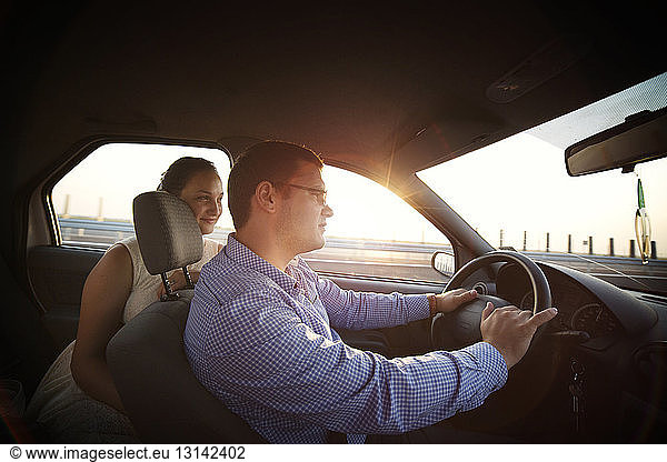 Man and woman travelling in car