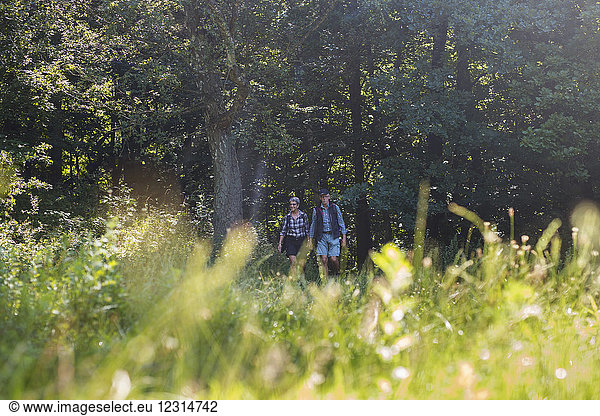 Man and woman walking in meadow